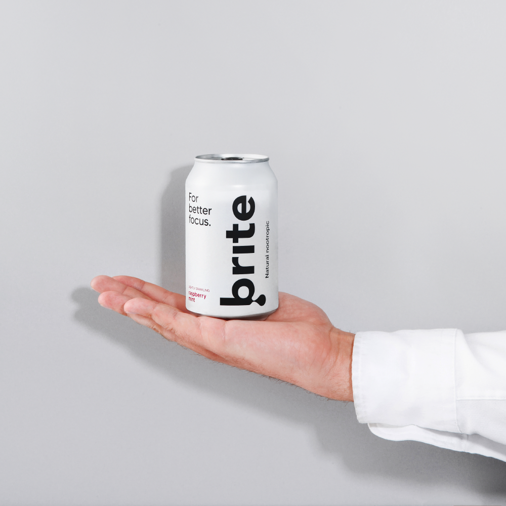 Brite raspberry mint nootropic drink in a can on a hand.